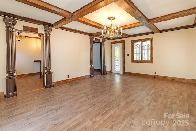 interior space featuring ornate columns, beamed ceiling, a chandelier, light hardwood / wood-style flooring, and coffered ceiling