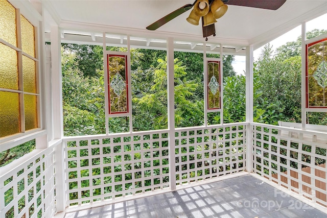 unfurnished sunroom with ceiling fan