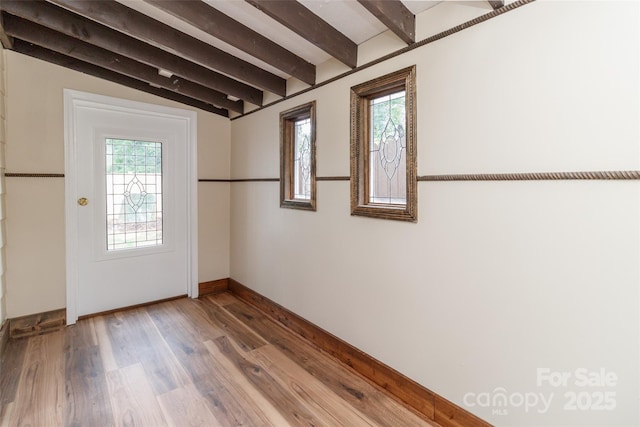 doorway to outside featuring lofted ceiling with beams and wood-type flooring