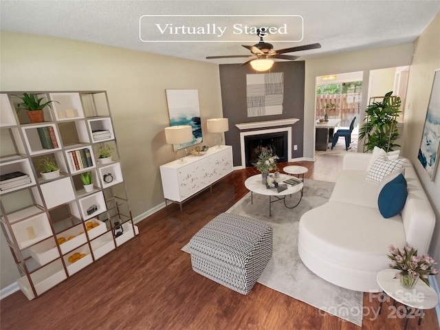 living room with ceiling fan and dark hardwood / wood-style flooring