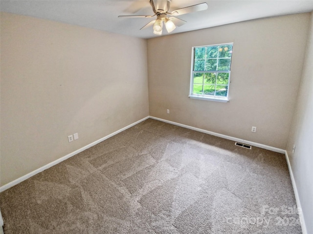 spare room featuring ceiling fan and carpet