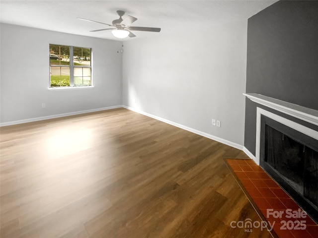 6003 Heath Valley Rd, Charlotte, NC 28210 - unfurnished living room featuring a fireplace with flush hearth, wood finished floors, a ceiling fan, and baseboards