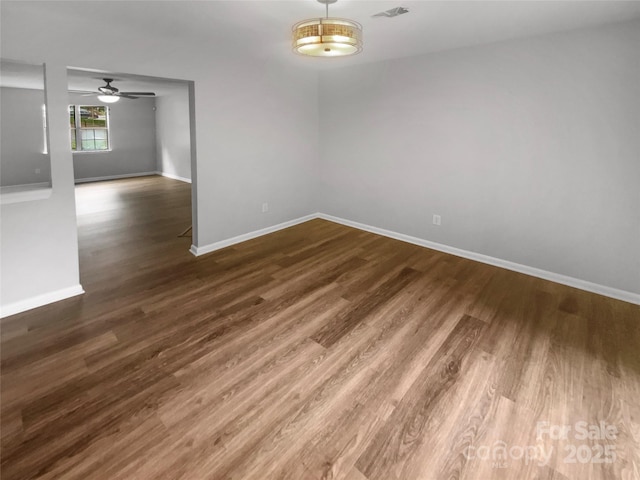 6003 Heath Valley Rd, Charlotte, NC 28210 - spare room with dark wood-style floors, baseboards, and ceiling fan