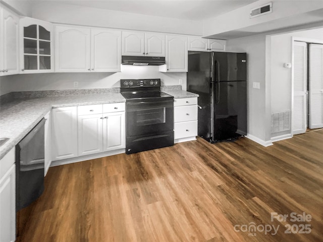 6003 Heath Valley Rd, Charlotte, NC 28210 - kitchen featuring black appliances, under cabinet range hood, white cabinetry, glass insert cabinets, and dark wood-type flooring