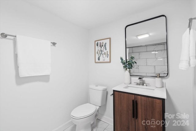 full bath featuring marble finish floor, baseboards, vanity, and toilet