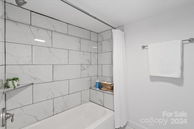 bathroom with shower / bath combo with shower curtain