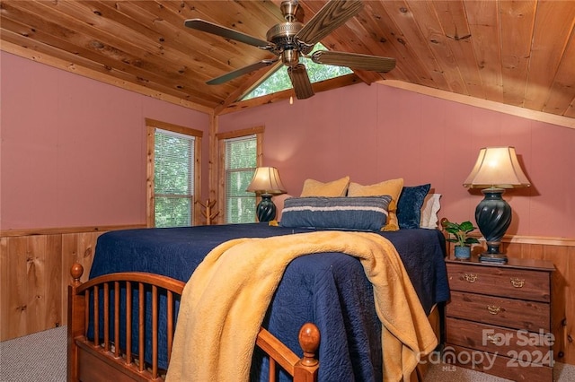 carpeted bedroom featuring lofted ceiling, wooden ceiling, ceiling fan, and wood walls