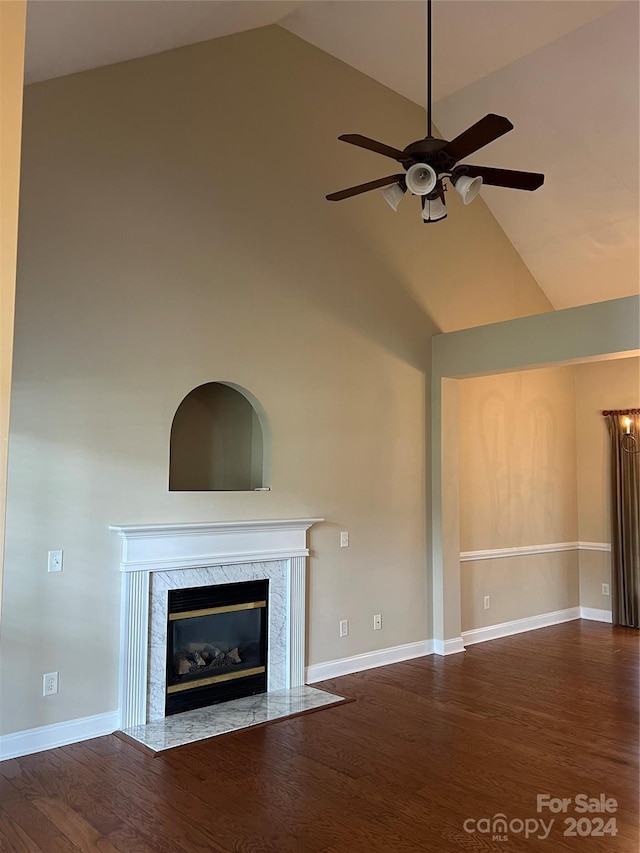 unfurnished living room with ceiling fan, high vaulted ceiling, dark hardwood / wood-style floors, and a fireplace