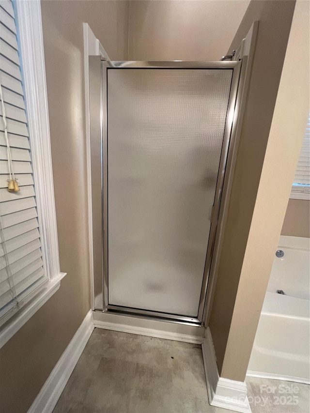 bathroom featuring shower with separate bathtub and concrete floors