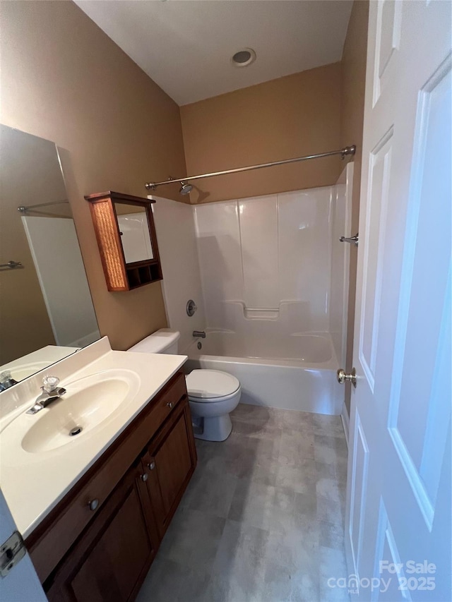 full bathroom with vanity, shower / tub combination, and toilet