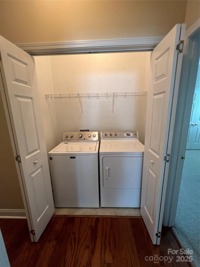 laundry room featuring dark hardwood / wood-style flooring and washing machine and dryer