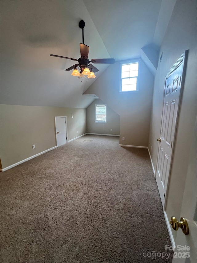 additional living space with lofted ceiling, carpet floors, and ceiling fan