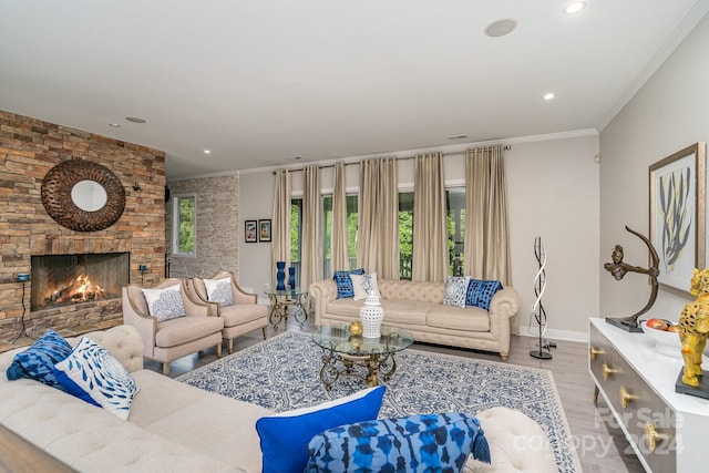 living room with ornamental molding, light hardwood / wood-style flooring, and a wealth of natural light