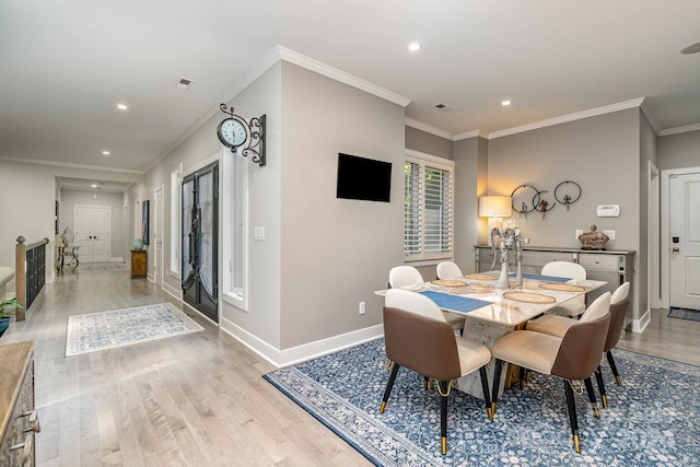 dining area featuring crown molding and light hardwood / wood-style floors