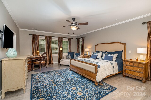 bedroom featuring hardwood / wood-style flooring, ornamental molding, and ceiling fan