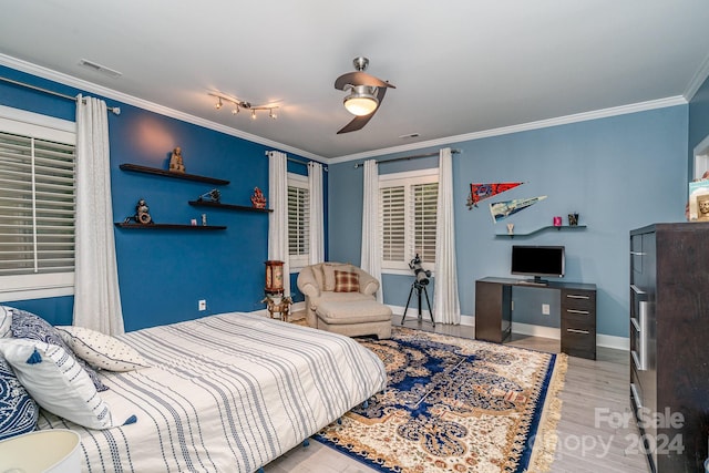 bedroom with crown molding, rail lighting, light hardwood / wood-style flooring, and ceiling fan