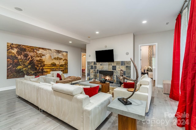 living room featuring a fireplace and light hardwood / wood-style flooring