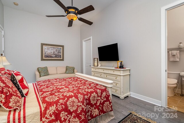 bedroom with connected bathroom, ceiling fan, and hardwood / wood-style floors