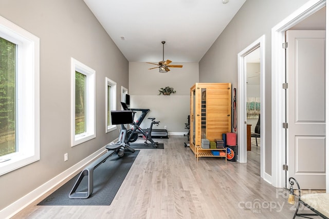 workout room with ceiling fan and light hardwood / wood-style flooring