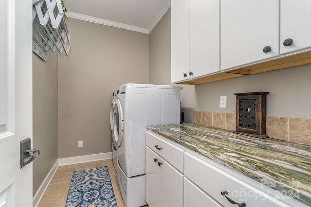 clothes washing area with independent washer and dryer, cabinets, crown molding, and light tile patterned floors