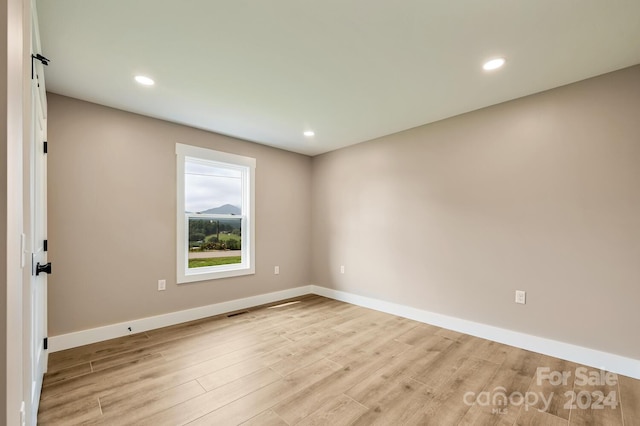 unfurnished room featuring light wood-type flooring