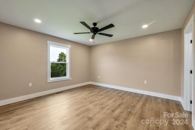 spare room featuring light hardwood / wood-style flooring and ceiling fan