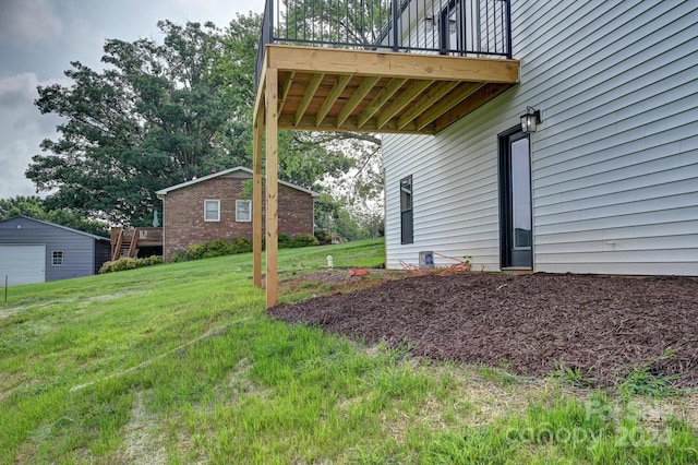 view of yard with a balcony and a garage