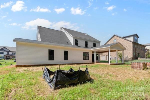 back of house with a yard