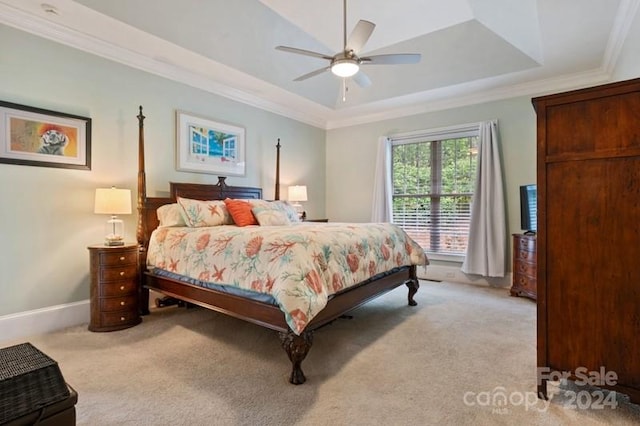 carpeted bedroom featuring a raised ceiling, crown molding, and ceiling fan