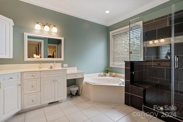 bathroom featuring tile patterned floors, vanity, crown molding, and a bath