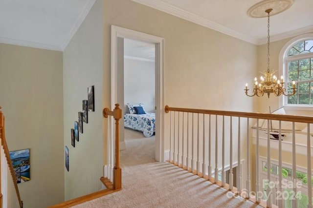 corridor with carpet, crown molding, and a chandelier