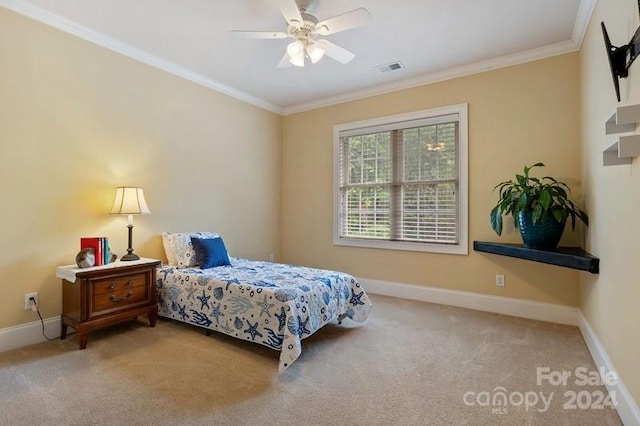 carpeted bedroom featuring ceiling fan and crown molding