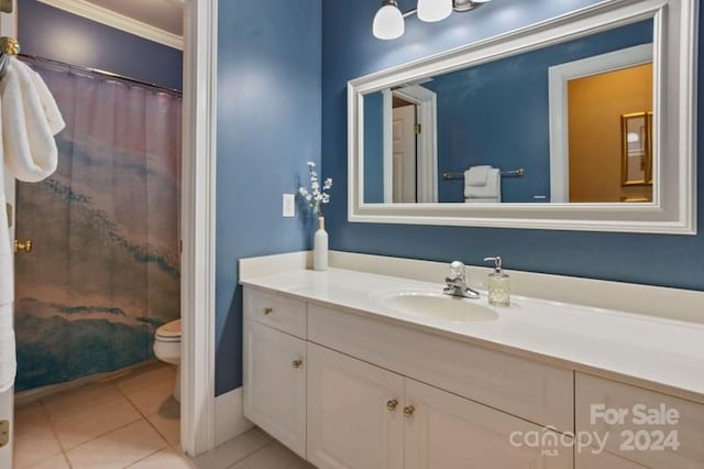 bathroom with tile patterned floors, toilet, vanity, and ornamental molding