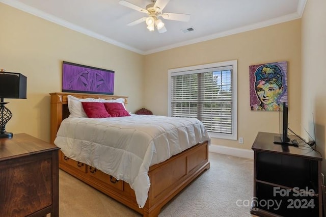 carpeted bedroom with ceiling fan and ornamental molding