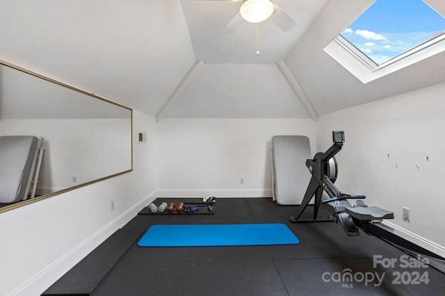 workout room with lofted ceiling with skylight and ceiling fan