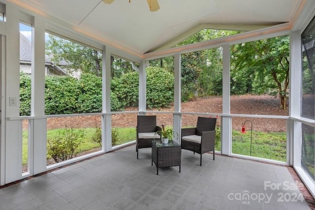 sunroom featuring lofted ceiling, a wealth of natural light, and ceiling fan