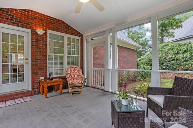 sunroom featuring vaulted ceiling and ceiling fan