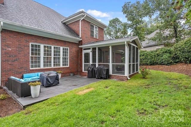 rear view of property featuring a sunroom, a lawn, and an outdoor hangout area