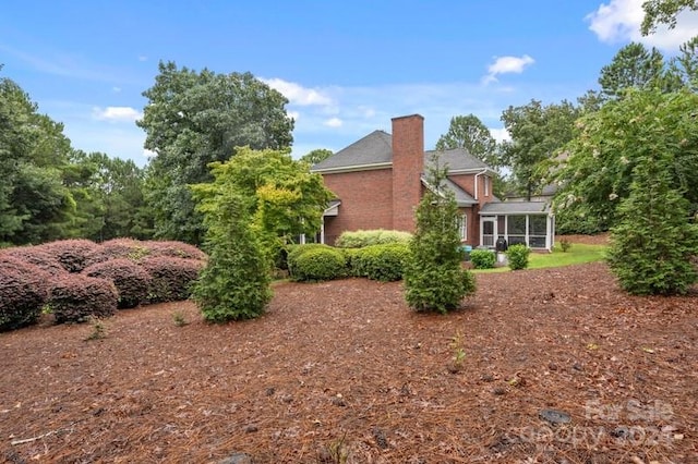 view of home's exterior with a sunroom