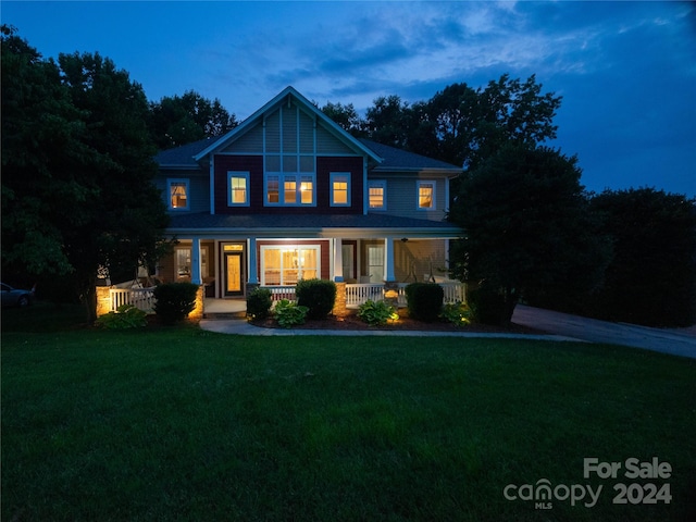 front of property featuring a yard and covered porch