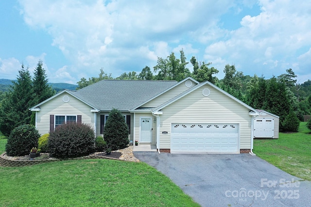 single story home with a garage and a front yard