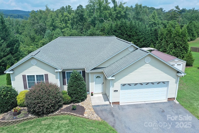 view of front property with a garage and a front yard