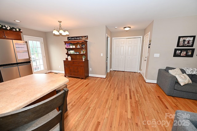 interior space with a notable chandelier and light hardwood / wood-style floors