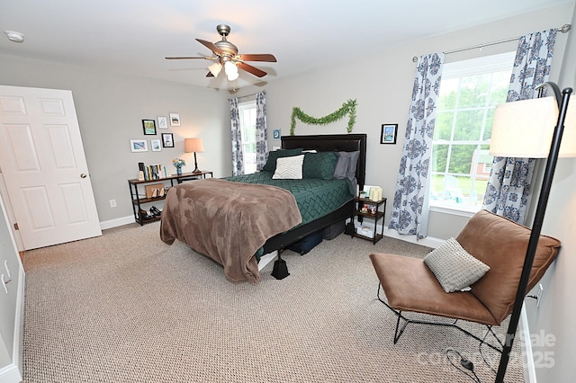 bedroom with ceiling fan and light carpet