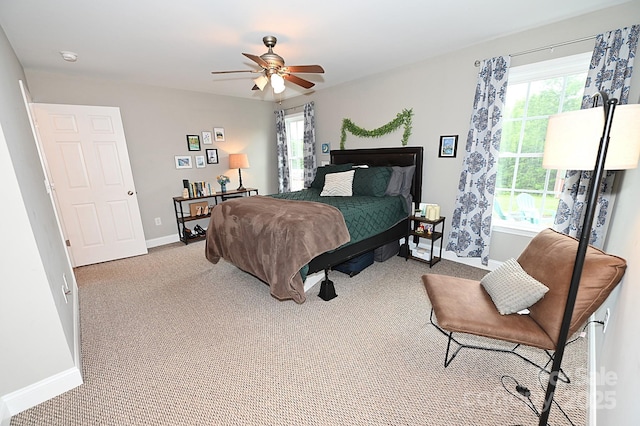 bedroom with multiple windows, light colored carpet, and ceiling fan