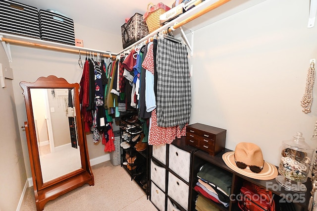 spacious closet featuring light carpet