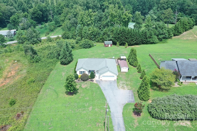 birds eye view of property with a rural view