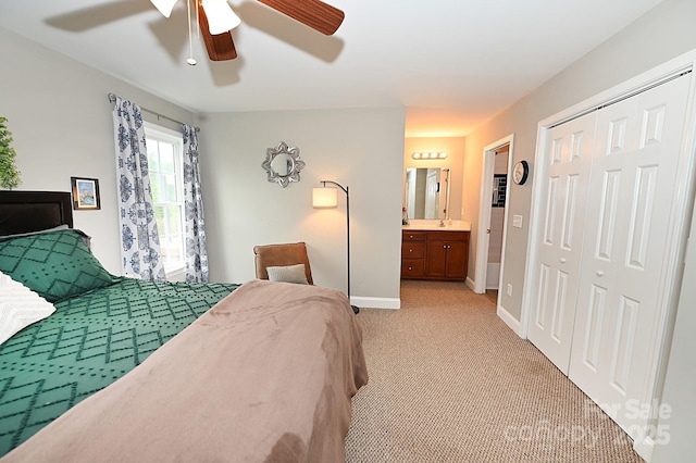 carpeted bedroom featuring a closet, ceiling fan, and ensuite bathroom