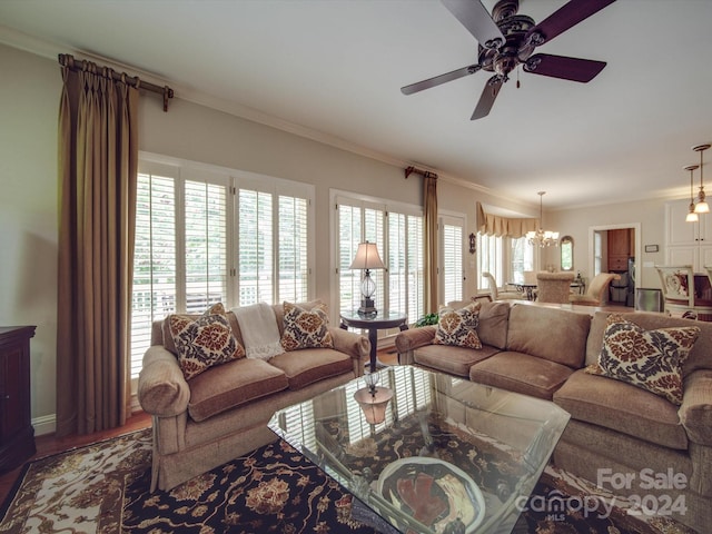 living room with plenty of natural light, crown molding, ceiling fan with notable chandelier, and hardwood / wood-style flooring