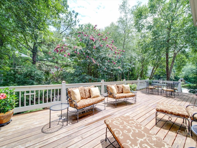 wooden terrace featuring an outdoor living space